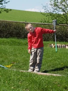 Boy playing minigolf Stock Photos