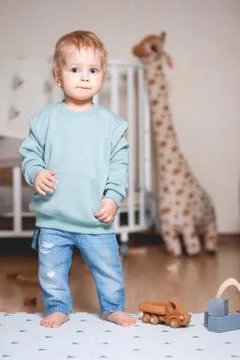 A boy is playing in a Mint colored hooded sweater Stock Photos