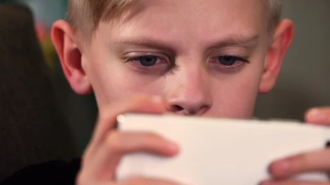 Boy playing mobile game - Face Closeup Stock Footage 87499402