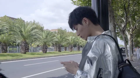 Boy playing mobile game happily Stock Footage 240973512