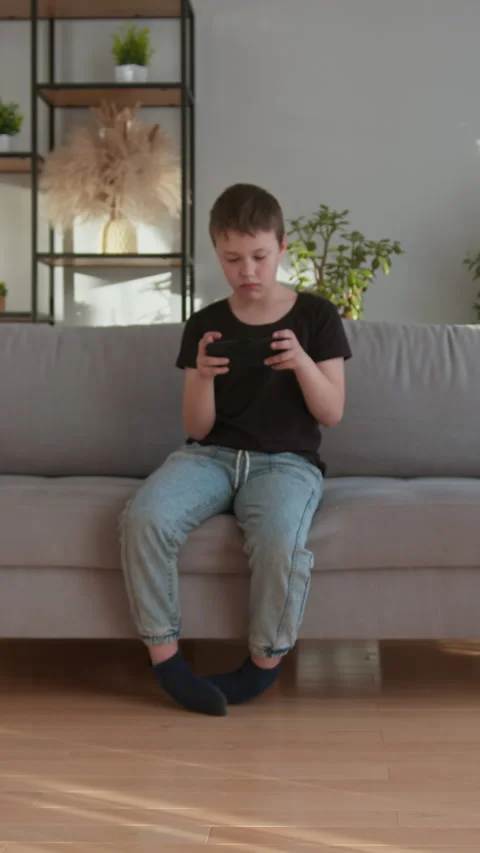 Boy Playing Mobile Game Indoors Stock Footage 335483729