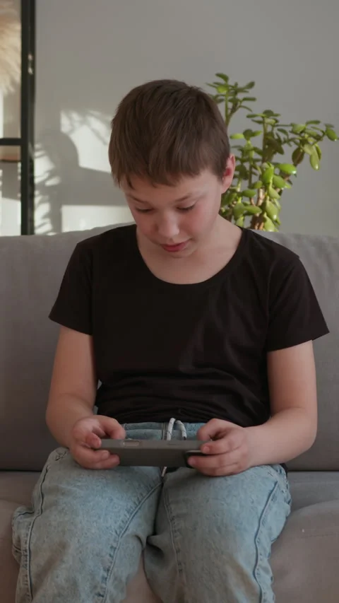 Boy Playing Mobile Game Indoors Stock Footage 335483836