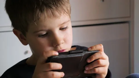 Boy Playing Mobile Game on Smartphone. Preschooler Playing Mobile Phone. Kid Vídeos de archivo 141292382