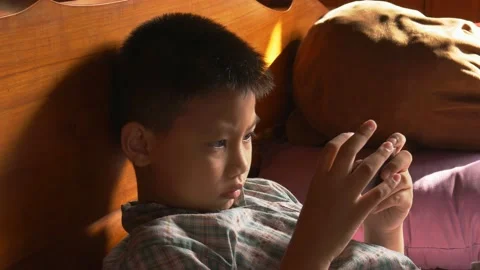 Boy playing mobile game on smartphone 動画素材 141742341