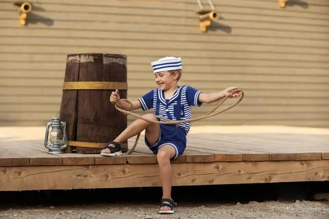 A boy is playing with a model of a sailing ship. Foto stock