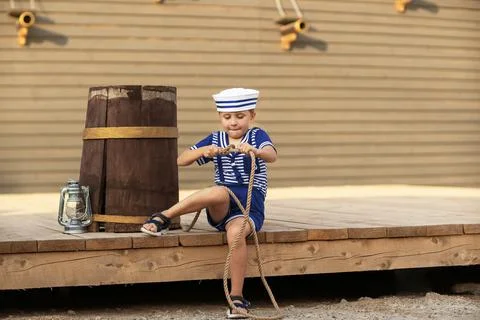 A boy is playing with a model of a sailing ship. Foto stock