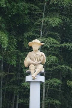 Boy playing music statue Stock Photos