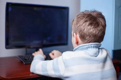 Boy playing online computer game in his room. Hobby and leisure, Stock Photos