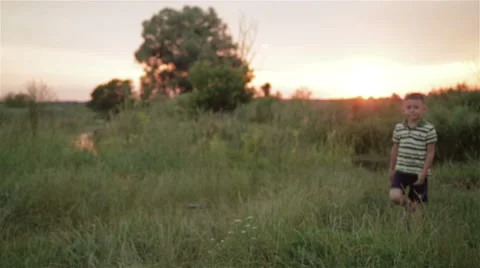 Boy playing outdoors Stock Footage 65077541