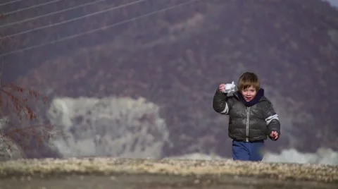 Boy playing outdoors in the winter Stock Footage 63852552