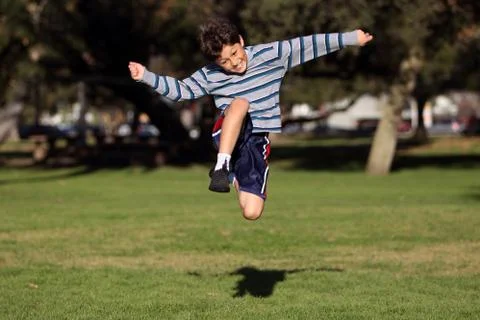 Boy playing in the park Stock Photos