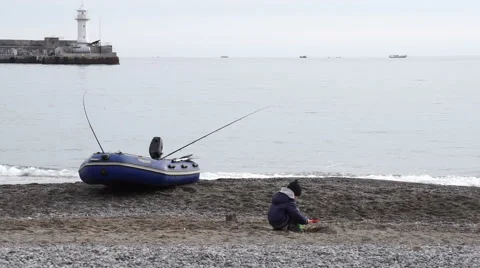 Boy playing on a pebble beach 動画素材 59052974