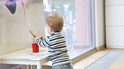 Boy playing with pencils Stock Footage 79752550