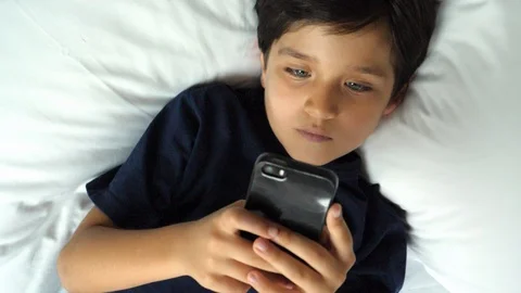 Boy playing on phone Stock Footage 88908674