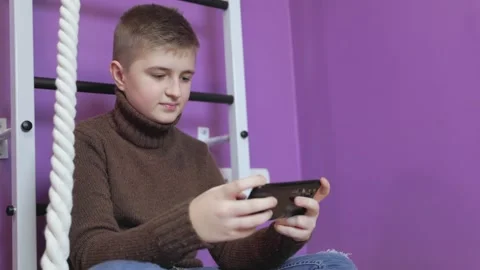 Boy playing on the phone Stock Footage 178532672