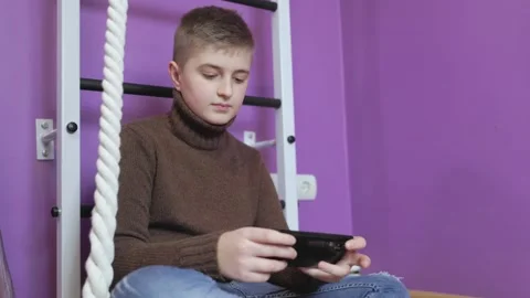 Boy playing on the phone Stock-Footage 184098379