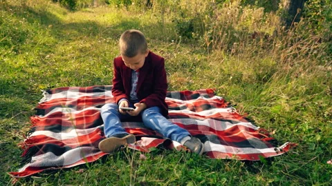 Boy playing on phone in games Stock Footage 96036217