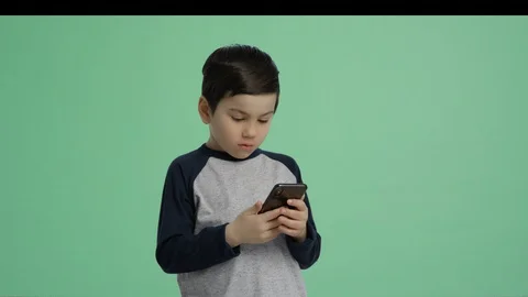 Boy playing with phone - green screen alpha channel lifestyle boy isolated Stock Footage 128991141