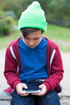 Boy playing on phone Foto stock