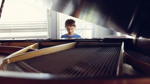 Boy playing piano Video stock 95747759
