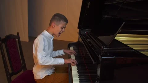 Boy playing the piano Stock Footage 141608269