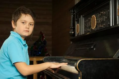 Boy is playing the piano Stock Photos