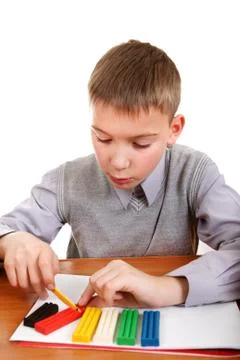 Boy playing with Plasticine Foto stock