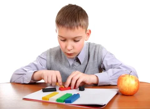 Boy playing with Play Dough Foto stock