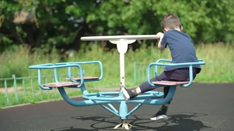 The boy is playing on the playground. Video stock 344811589