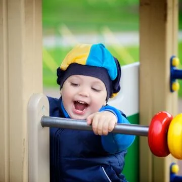 Boy playing on playground Stock Photos
