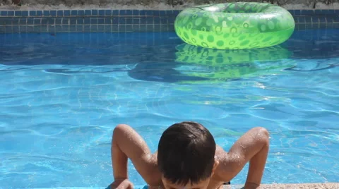 Boy playing in the pool Stock Footage 1066364
