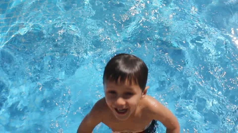 Boy playing in pool Stock Footage 1067627
