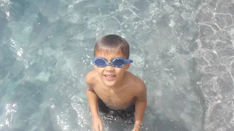 Boy playing in pool Stock Footage 11632181