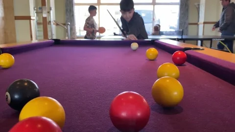 A boy playing pool Stock Footage 238440983