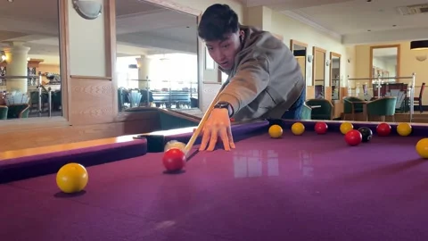A boy playing pool Stock Footage 238440985