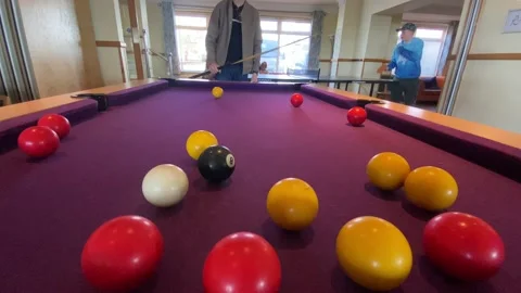 A boy playing pool Stock Footage 238440990