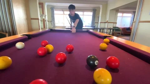 A boy playing pool Stock Footage 238473884