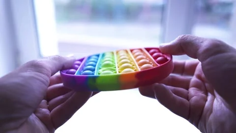 Boy playing with Popit push pop bubble fidget toy Video stock 205616778