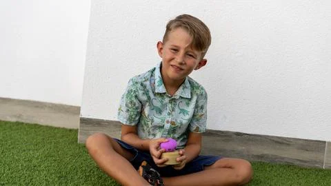 Boy Playing with a Popular Purple Dumpling Stress Relief Toy Фото