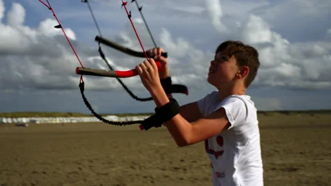 Boy playing with powerkite on the beach Stock Footage 285132079