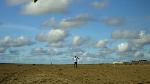 Boy playing with powerkite on the beach Stock Footage 285132646