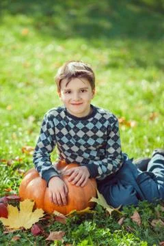 Boy Playing With Pumpkin Stock Photos