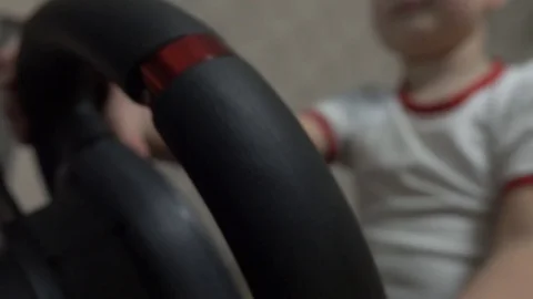 Boy playing racing computer game using steering wheel. 4K video Stock Footage 73440824