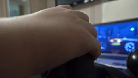 Boy playing racing computer game using steering wheel. 4K clip 動画素材 73440977