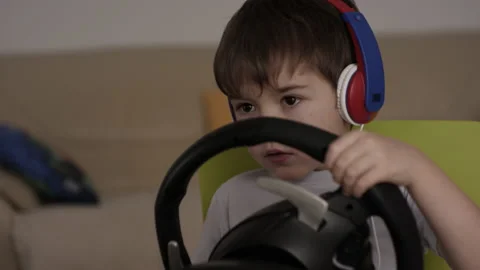 Boy Playing Racing Video Game in Game Console. Child Playing Computer Game in Stock Footage 168465270