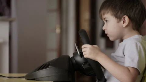 Boy Playing Racing Video Game in Game Console. Child Playing Computer Game .. Stock Footage 339302556