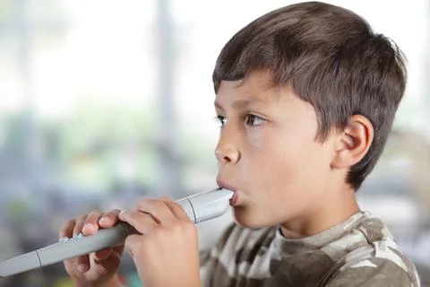 Boy playing recorder Stock Photos