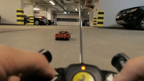 Boy playing  with a remote-controlled car in garage hall Stock-Footage 101738074
