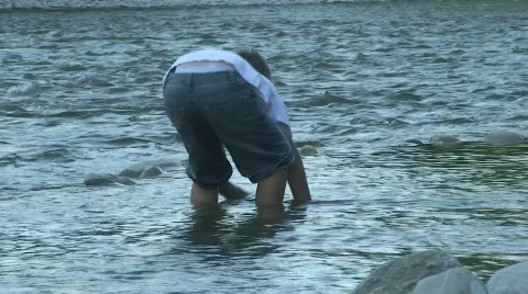 Boy playing in river Stock Footage 808066