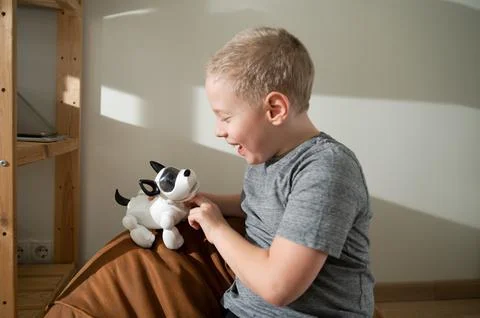 Boy playing with robotic dog Stock Photos